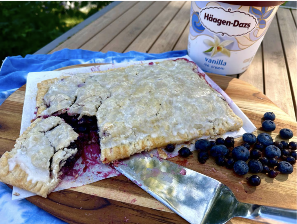 Large blueberry pop tart and ice cream on a table